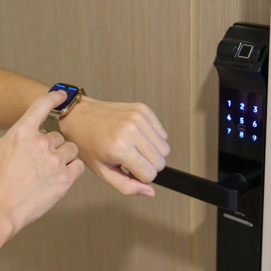 A person using a smart building technology system to open a door