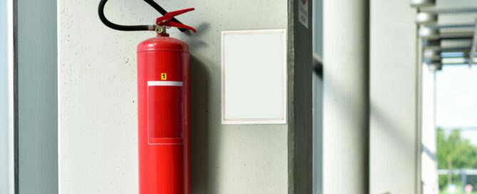 lithium battery fire extinguisher hanging on wall of commercial building