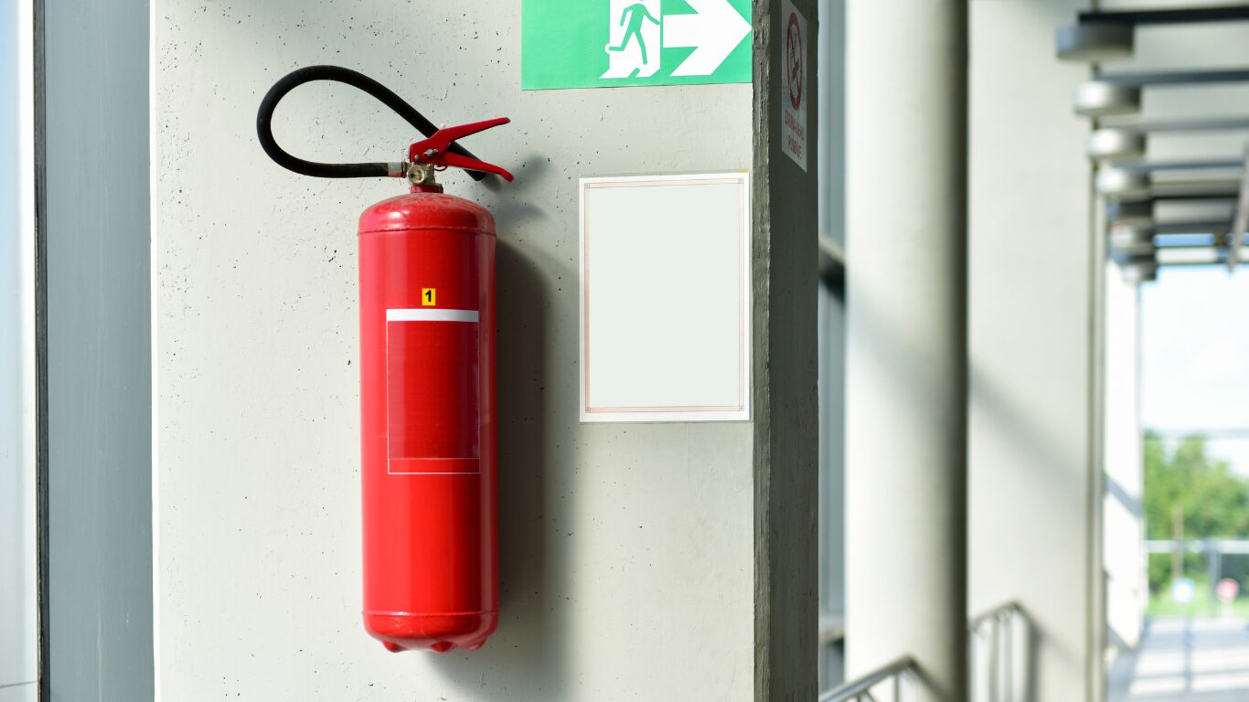 lithium battery fire extinguisher hanging on wall of commercial building