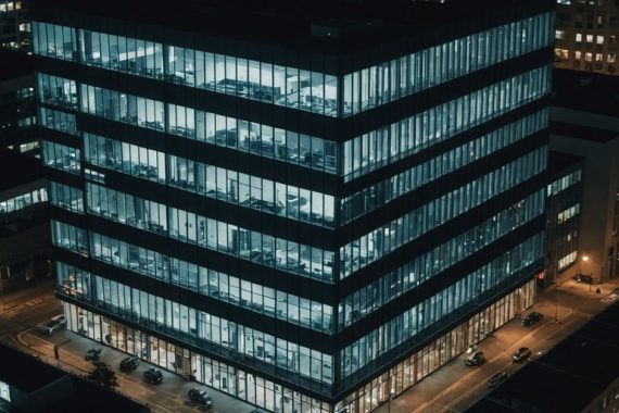 Office building with AI surveillance cameras at night.